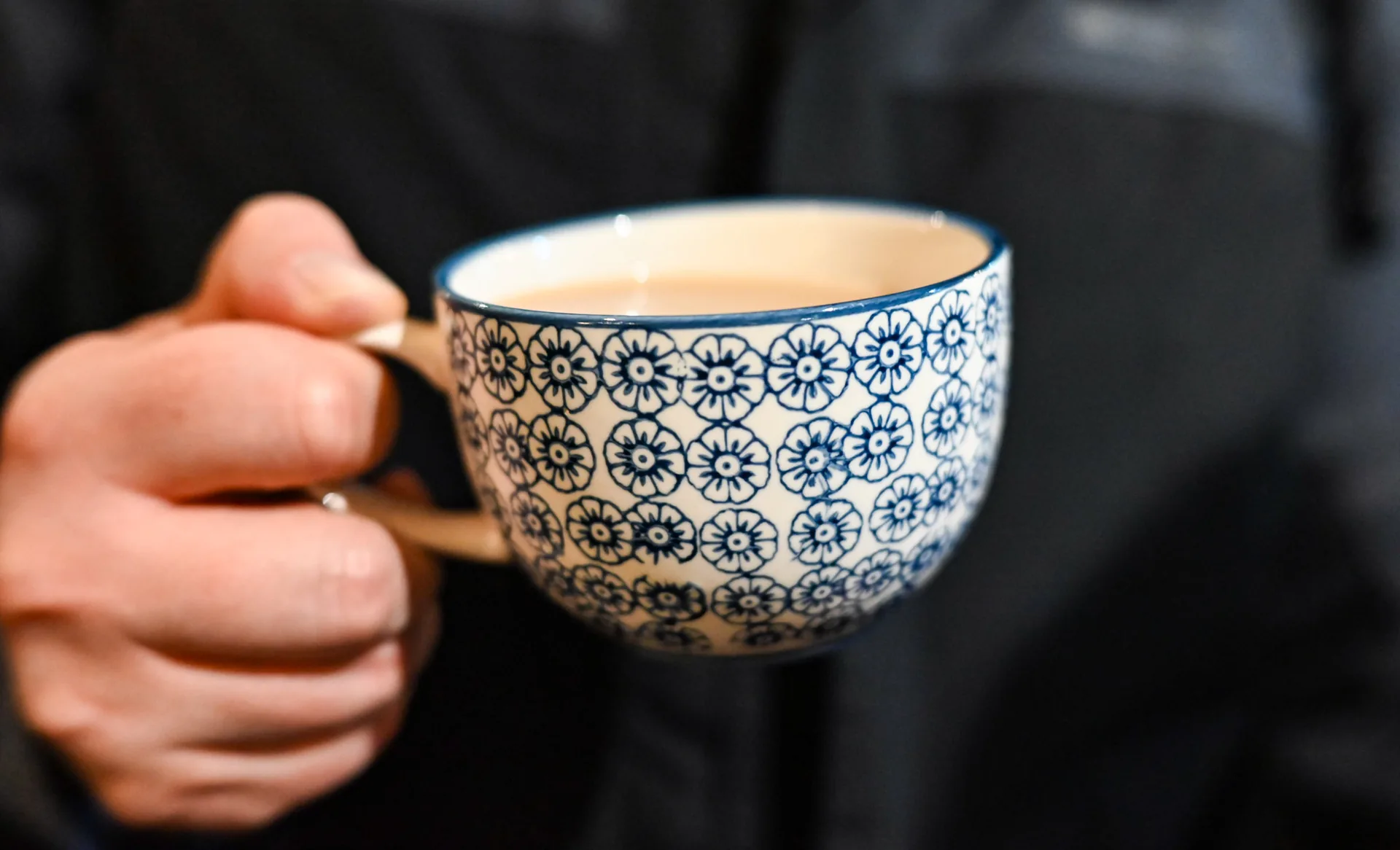Hand holding a patterned cup — Bromley Photography, Chislehurst